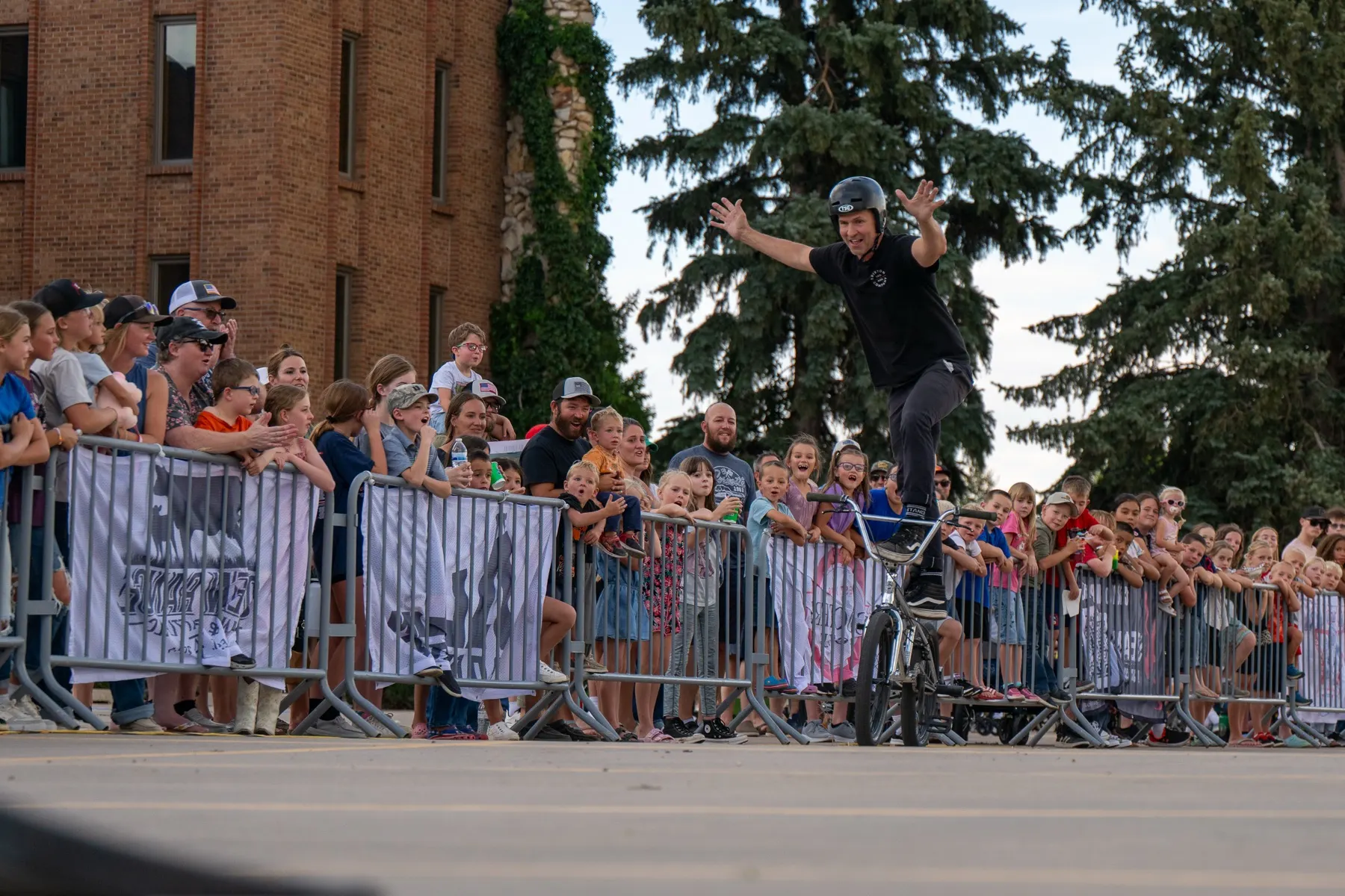 StuntDudes rider backflipping over the barrier at a downtown street show