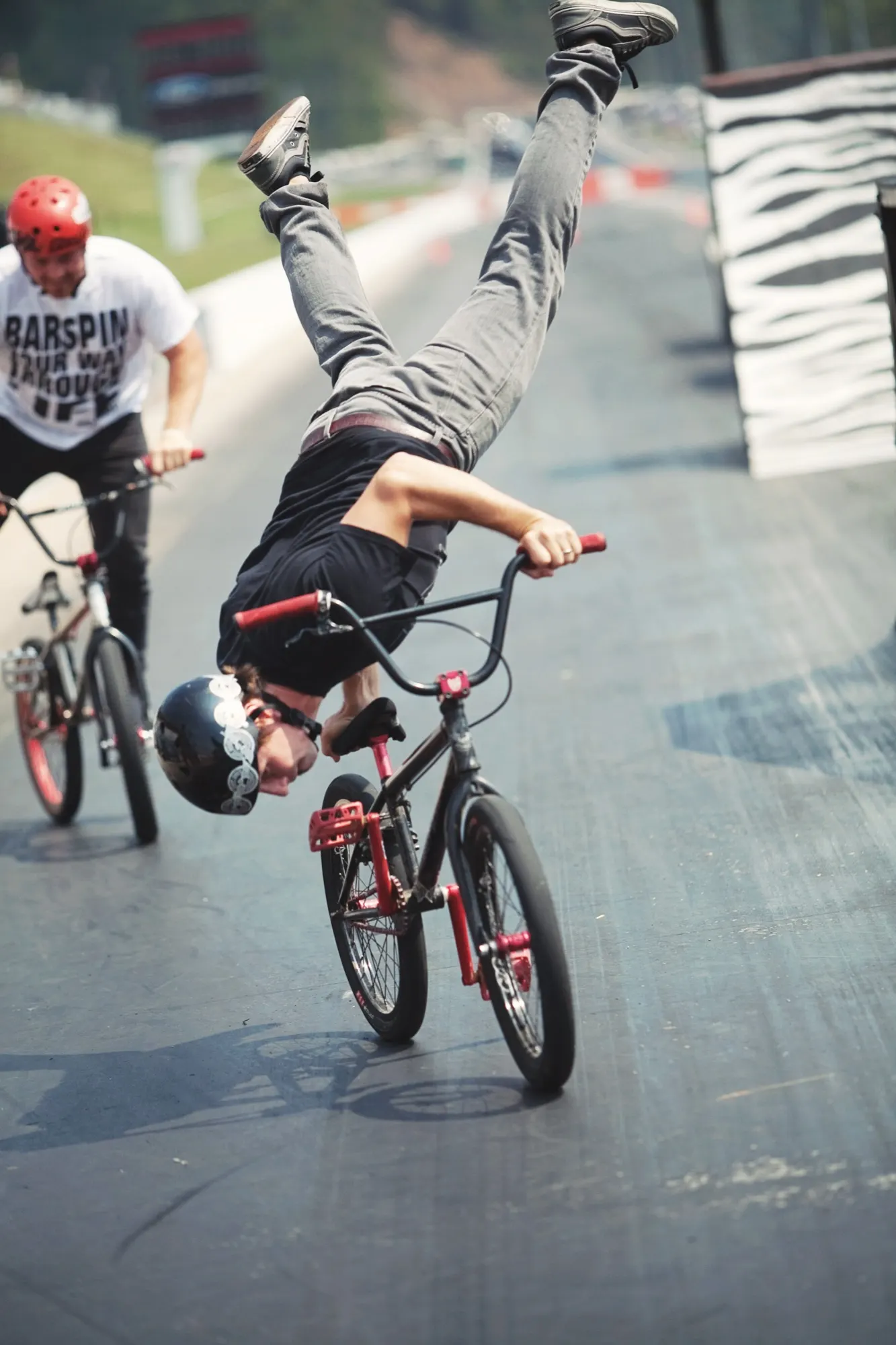 StuntDudes rider throwing a barspin down the track