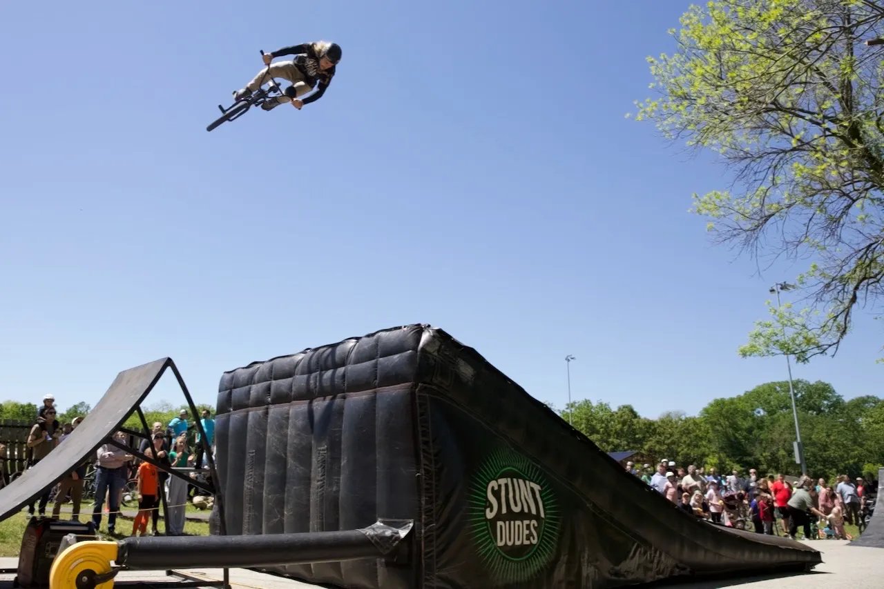 StuntDudes rider boosting huge air off the branded ramp